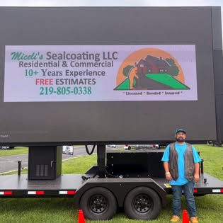 Miceli's owner beside sealcoating equipment